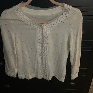 White cardigan light weight sweater with silver beading and sheer white trim.